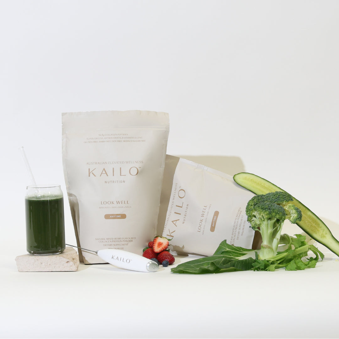 Two packages of KAILO brand supplements labeled 'Look Well' with a selection of fruits and vegetables around them, presented on a white background.