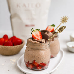 Chocolate mousse in jars with strawberries on a white plate, KAILO bag in the background.