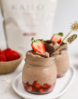 Chocolate mousse in jars with strawberries on a white plate, KAILO bag in the background.