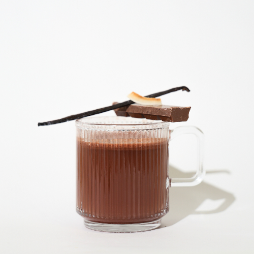 choco flavored drink in a glass cup with a slice of chocolate on top